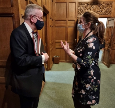 Caroline talking to Michael Gove on cladding issues affecting Eastbourne residents